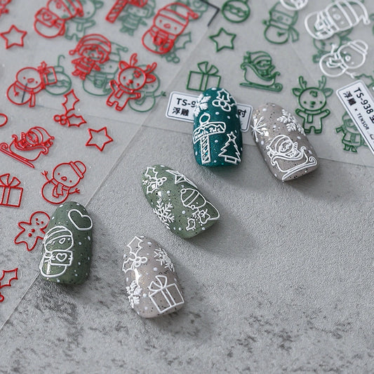 Christmas nail stickers with Santa Claus, reindeer and snowflake applied on nails – holiday nail art decals