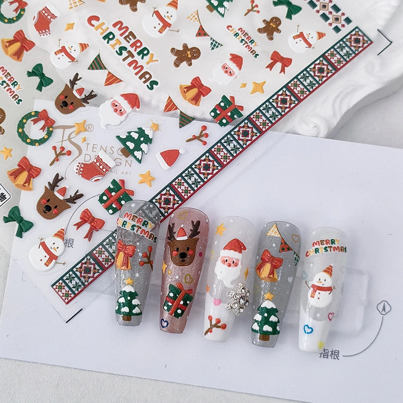 Christmas nail art stickers applied on nails with Santa, reindeer and festive holiday designs