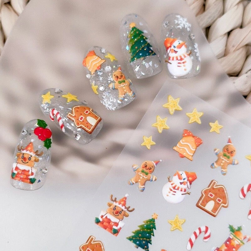 Christmas nail stickers with snowman, gingerbread house and Christmas tree applied on clear nails – festive holiday nail art